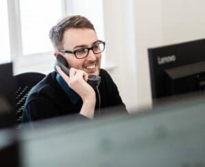 IT support engineer in Portsmouth helping a customer on the phone.